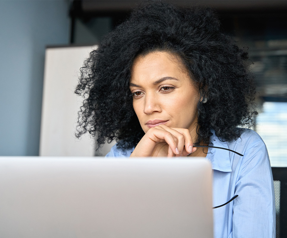 Young professional woman looking at laptop